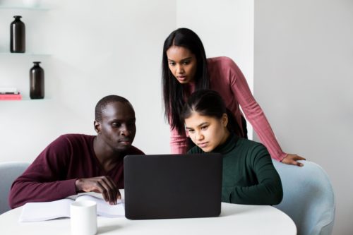 people at work looking at laptop