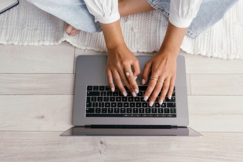 employee typing on laptop