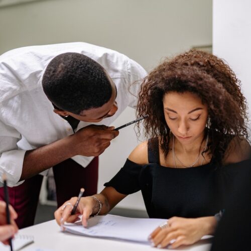 man close to woman at work