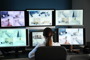 woman in front of surveillance computers