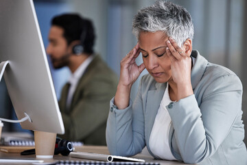 woman at work gripping head
